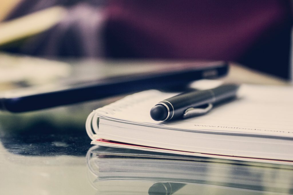 Notebook and pen – family law useful documents and resources for parents navigating legal proceedings.