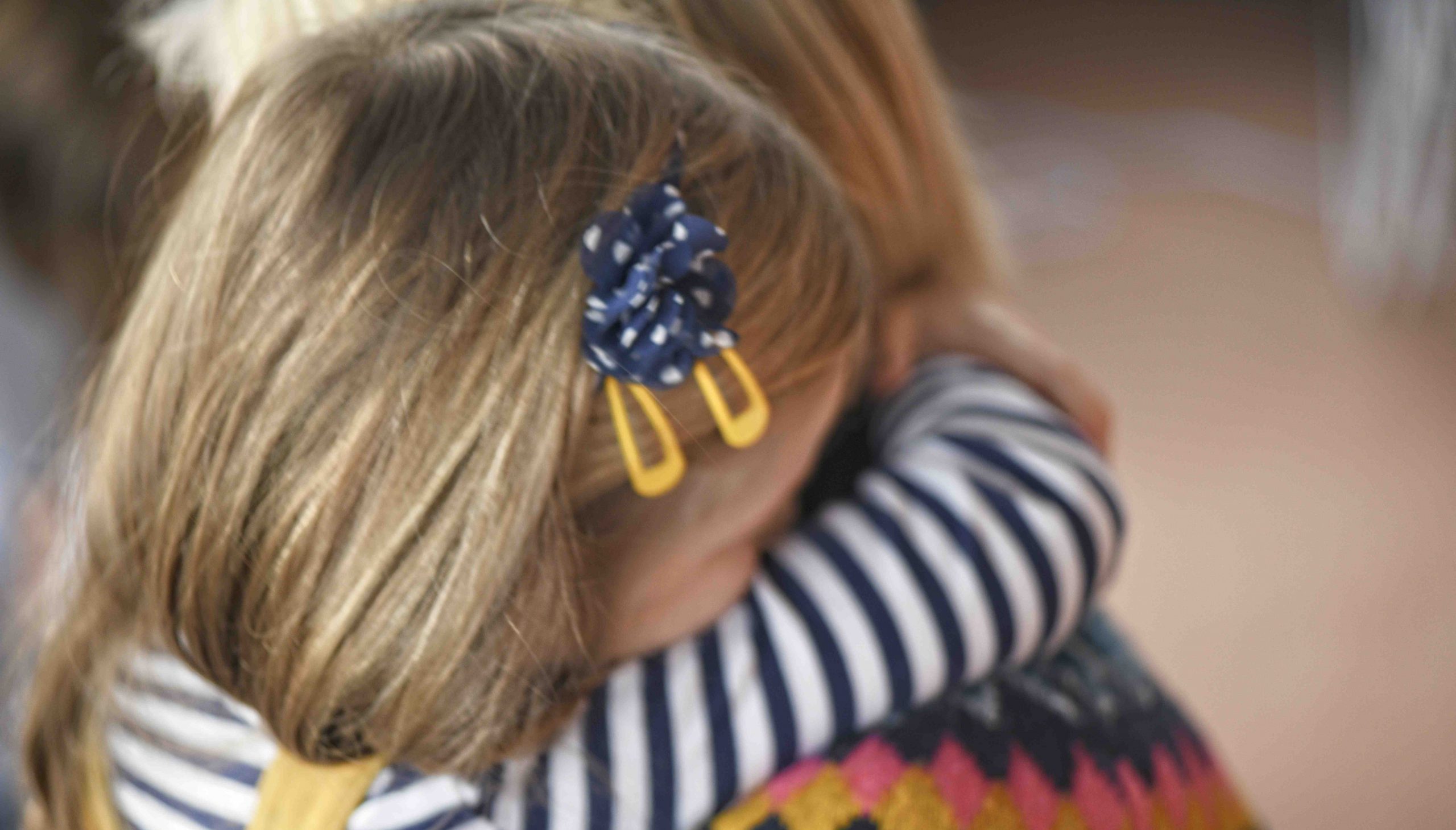 girl hugging mother