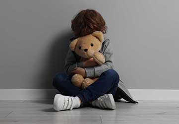 sad-child-holding-teddy