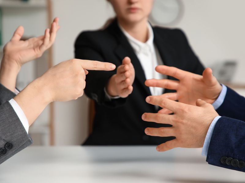 Family mediator helping two people discuss a family dispute during a mediation meeting